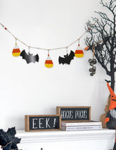 Halloween-themed decorations including a banner with candy corn and bats, a sign saying &