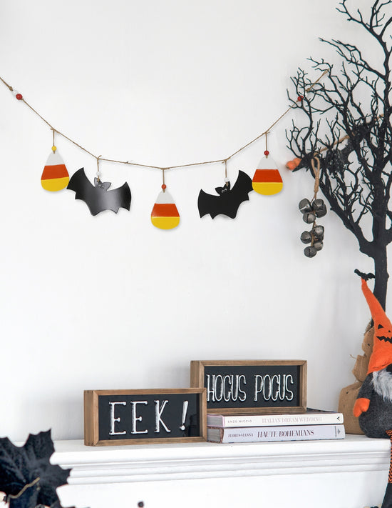 Halloween-themed decorations including a banner with candy corn and bats, a sign saying &