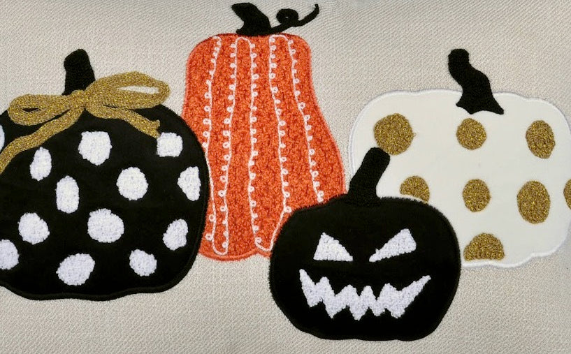 Set of Halloween-themed coasters with pumpkins on a neutral background