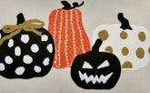 Set of Halloween-themed coasters with pumpkins on a neutral background