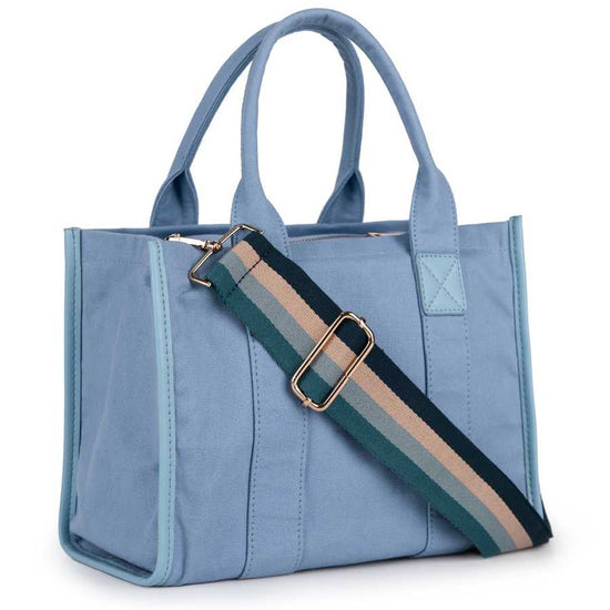 Blue tote bag with a striped shoulder strap on a white background