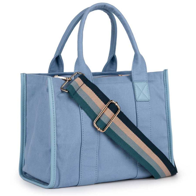 Blue tote bag with a striped shoulder strap on a white background