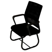 Black office chair in a room with red cabinets and a white rug.