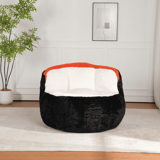 Black bean bag chair with red interior in a room with a plant and framed picture on the wall.