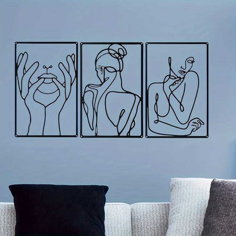 Abstract metal wall art set of 3 with black line art on a blue wall above a couch, perfect for stylish home or garden decoration.