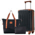 Black 20 inch carry on luggage with brown handle and wheels, accompanied by a black tote bag and small toiletry bag for travel