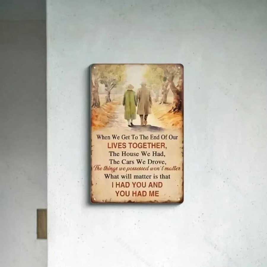 Metal wall art with sentimental quote displayed on a minimalist white wall, enhancing vintage-themed home decor.