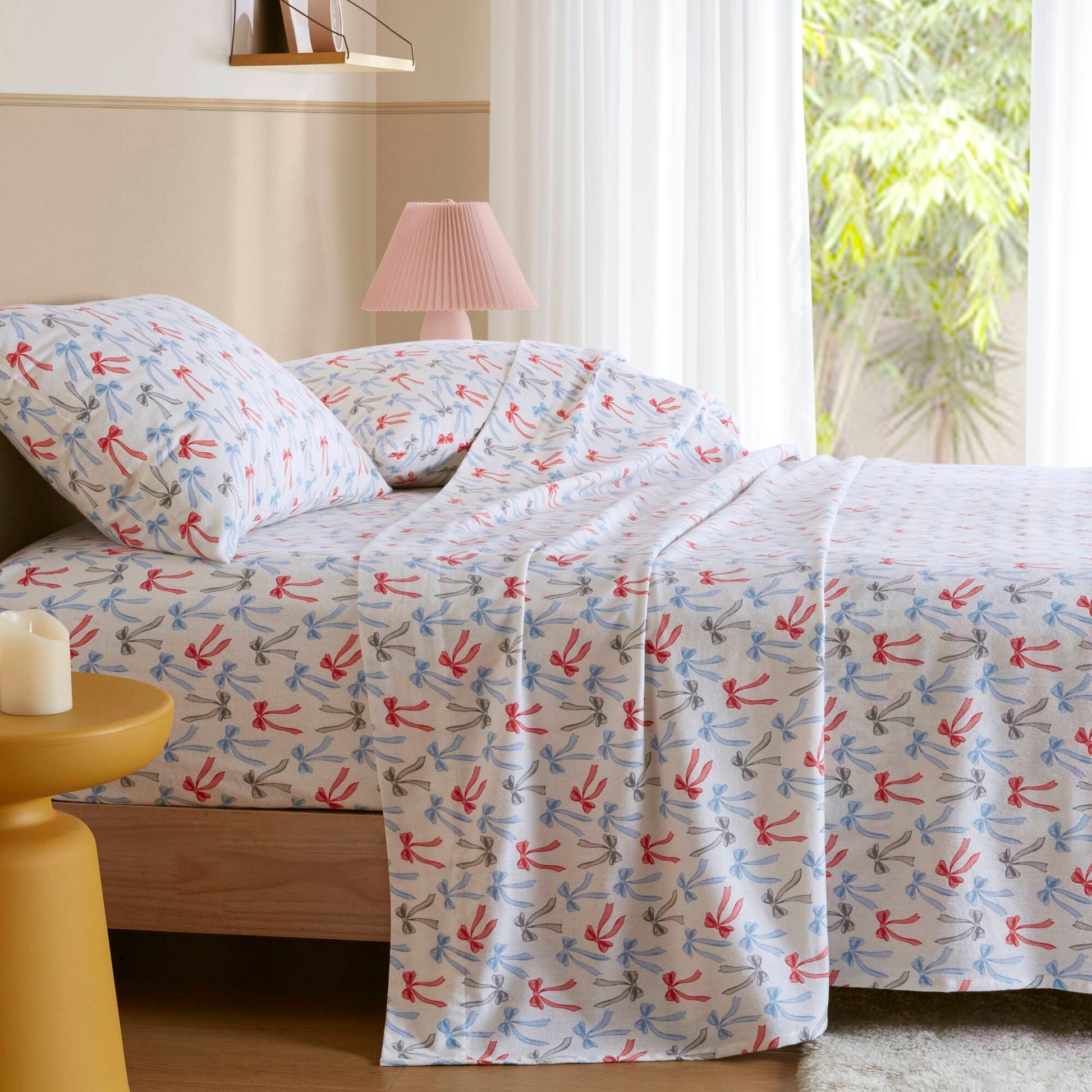 Happy Bows Twin XL Cotton Flannel Sheet Set styled on bed in sunlit room, perfect for cozy and stylish bedding.