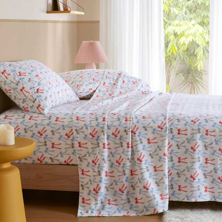 Happy Bows Twin XL Cotton Flannel Sheet Set styled on bed in sunlit room, perfect for cozy and stylish bedding.