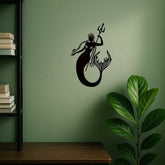 Mermaid Sea King Iron Relief Art on green wall near bookshelf and plant, a unique coastal accent for living room or study.