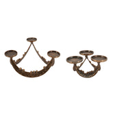Two ornate bronze candelabras with decorative scrollwork and three arms each, shown on a plain white background.