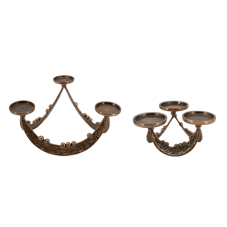 Two ornate bronze candelabras with decorative scrollwork and three arms each, shown on a plain white background.