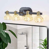 Bathroom vanity light fixture with glass shades on a mirror above a shower.