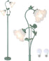 A green metal floor lamp designed like a flowering vine with three glowing frosted glass flower shades. Two bulb bulbs are shown separately at the bottom right against a plain white background.