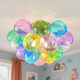 Colorful balloon chandelier hanging from a ceiling in a room with children&