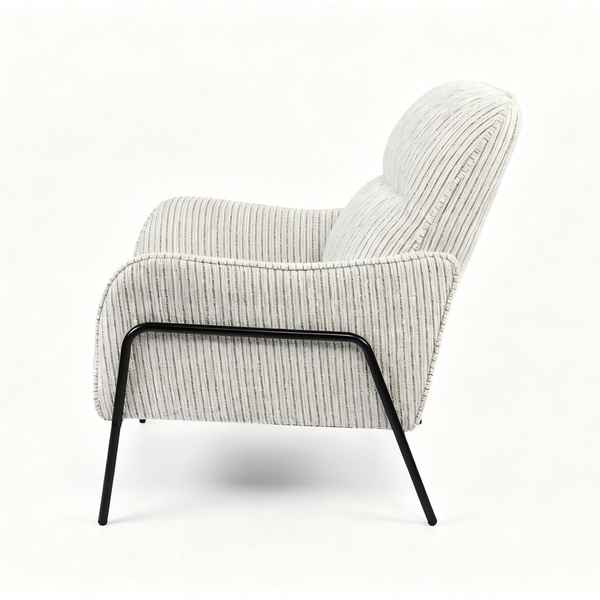 A modern upholstered armchair with a textured vertical stripe pattern in off-white and gray, supported by a sleek black metal frame, shown from a side profile on a white background.
