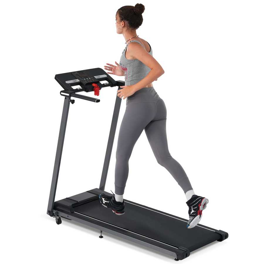 Woman running on foldable treadmill with digital display