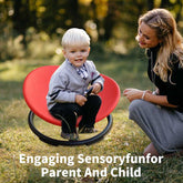 Child sitting on a red chair outdoors with a woman, text &