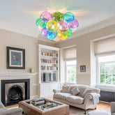 Living room with a colorful ceiling light fixture, bookshelf, and fireplace.