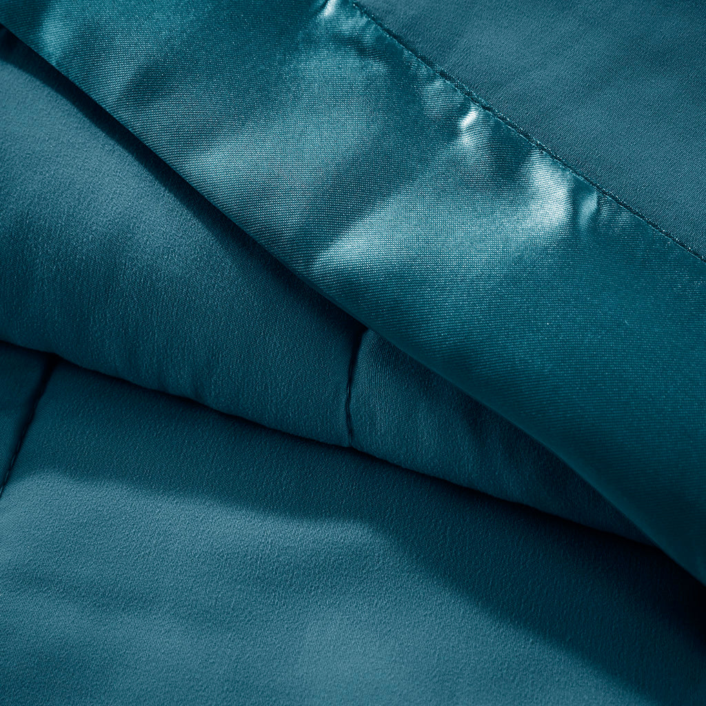 Close-up of Teal Twin Down Alternative Blanket showing soft microfiber texture and satin trim for luxurious bedding appeal.
