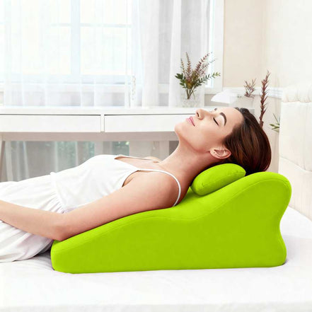 Woman reclining on Ergonomic Spinal Posture Support Pillow - Memory Foam, demonstrating its use for neck and upper back relaxation.