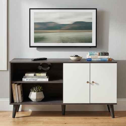 Stylish black and white wood TV stand with open shelves, cabinet doors, and angled legs, perfect for living room decor
