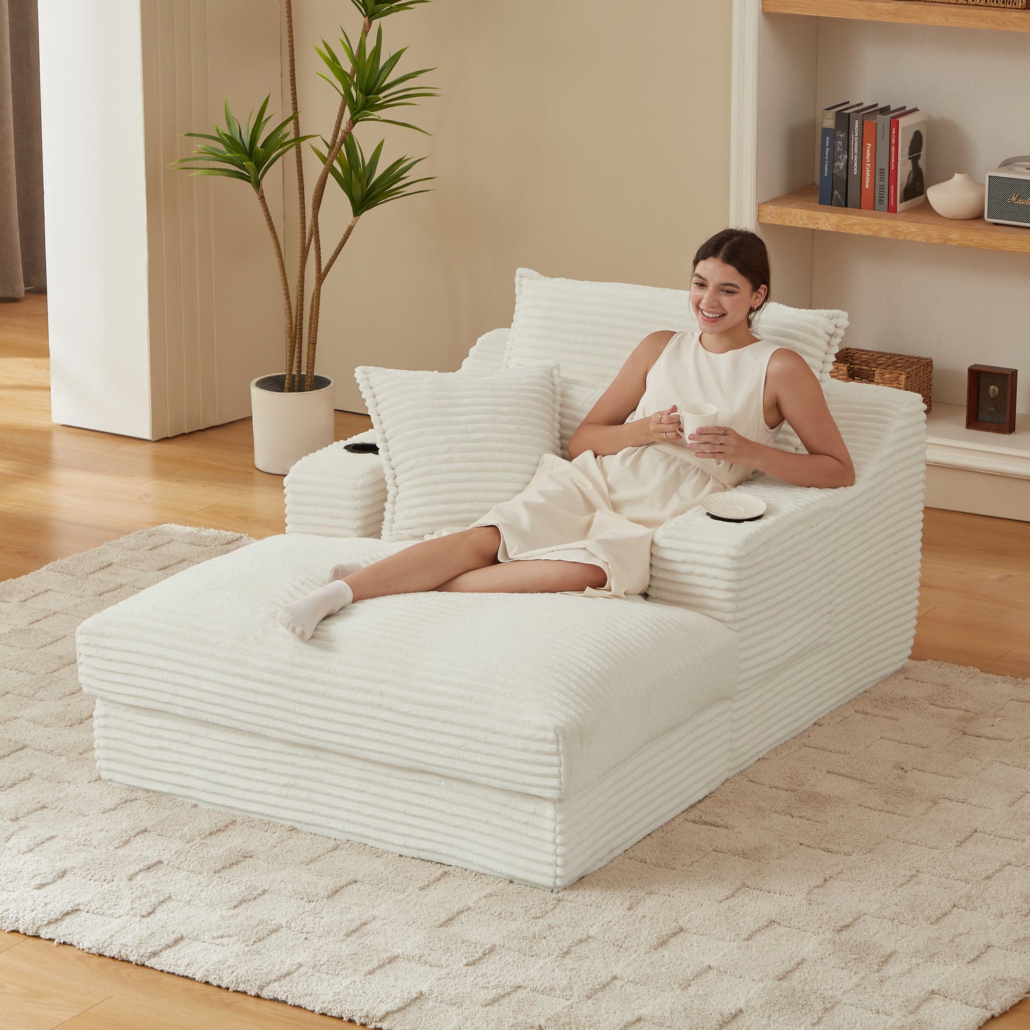 Woman sitting on a modern white lounge chair in a cozy living room.