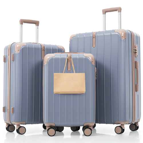 Set of three blue suitcases with beige handles and wheels on a white background