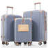 Set of three blue suitcases with beige handles and wheels on a white background