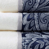 Close-up of white towels with navy and black paisley jacquard borders