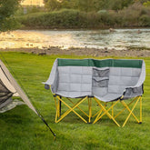 Camping chair with quilted design on grass near a river