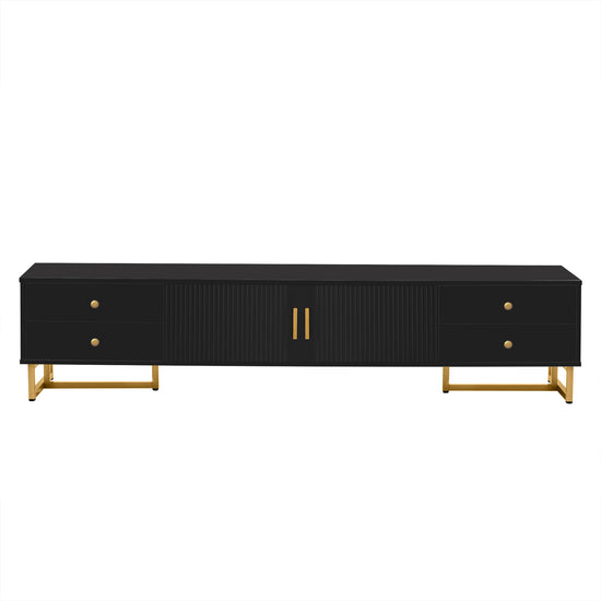 Black entertainment console with gold legs and handles on a white background