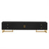 Black entertainment console with gold legs and handles on a white background