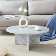MDF white round coffee table with Nordic flair placed in front of a sofa, showing its modern design and marble-like texture.