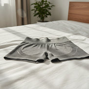 Dark gray seamless yoga shorts with contouring fit and high waist. Designed for comfort, flexibility, and flattering shape.