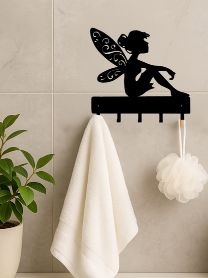 Black iron fantasy wall hook key holder with fairy silhouette on a tiled wall, holding a towel and bath sponge. Perfect for bathroom storage.