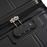 Close-up of a black suitcase with a silver zipper and a black tool attached.