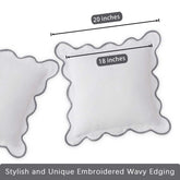 Two decorative pillows with wavy edges and measurements on a white background