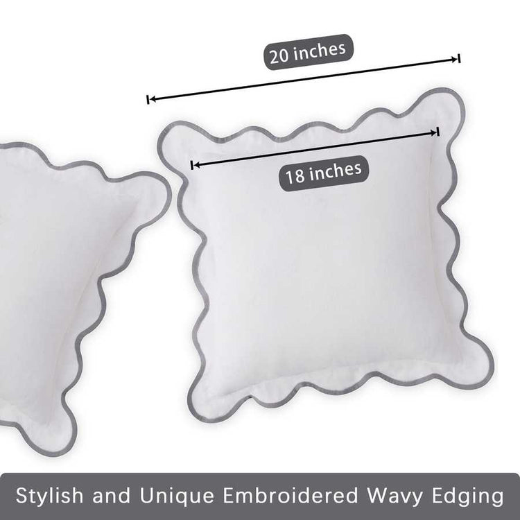 Two decorative pillows with wavy edges and measurements on a white background