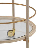 Close-up of a round glass-topped table with metal legs and wheels on a white background