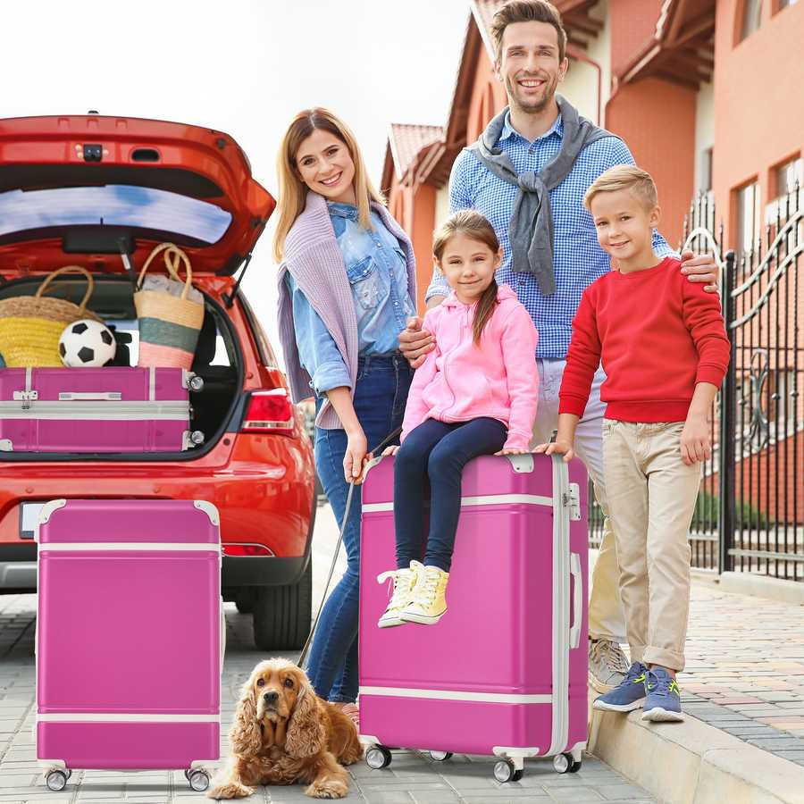 Family with children and a dog standing near a car with open trunk and pink suitcases.