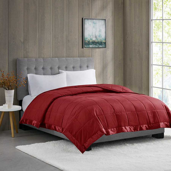 Down Alternative Blanket Burgundy Twin - Budget Comfort displayed on a modern bed with tufted headboard in a cozy bedroom setting.