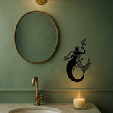 Coastal-themed Mermaid and Sea King Iron Relief Art beside round mirror in bathroom, enhancing ocean-inspired home decor.