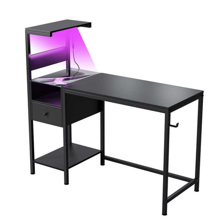 Black computer desk with USB ports and power outlet, featuring LED accent lighting and reversible shelves for modern workspace.