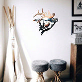 Decorative wall art of a deer head with antlers in a room with stools and a teepee.