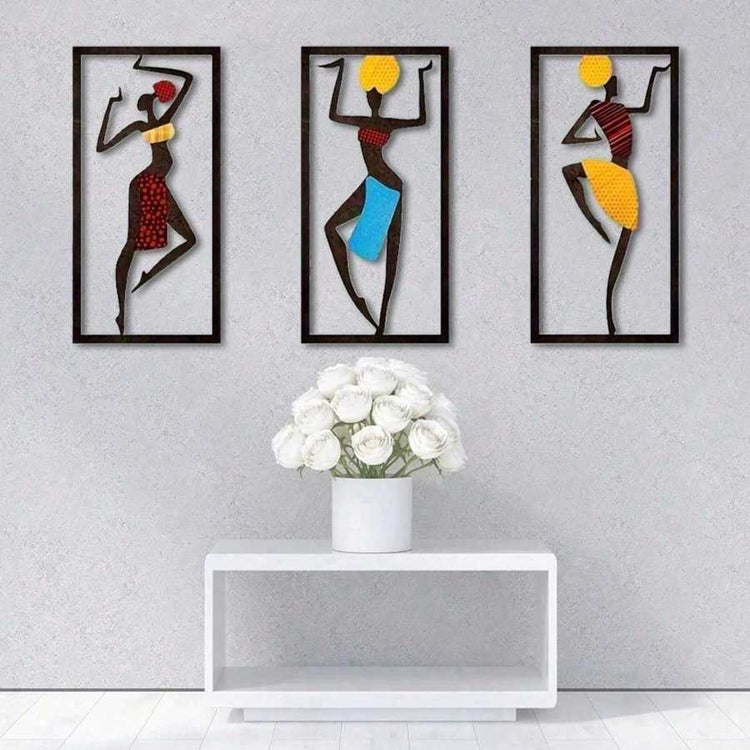 Bohemian Macrame Wall Hanging with African dancer artwork on a gray wall above a white console with white roses. Elegant handmade wall art.