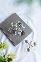 Pair of earrings on a Charles & Dave box with a blurred natural background