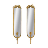 A pair of tall, narrow wall mirrors with ornate gold frames, bow details at the top, and candle-style holders at the bottom, shown on a plain white background.