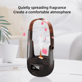 A modern black and copper fragrance diffuser with a digital display and misting function, shown on a white table with decorative text overlay and soft-focus background elements.