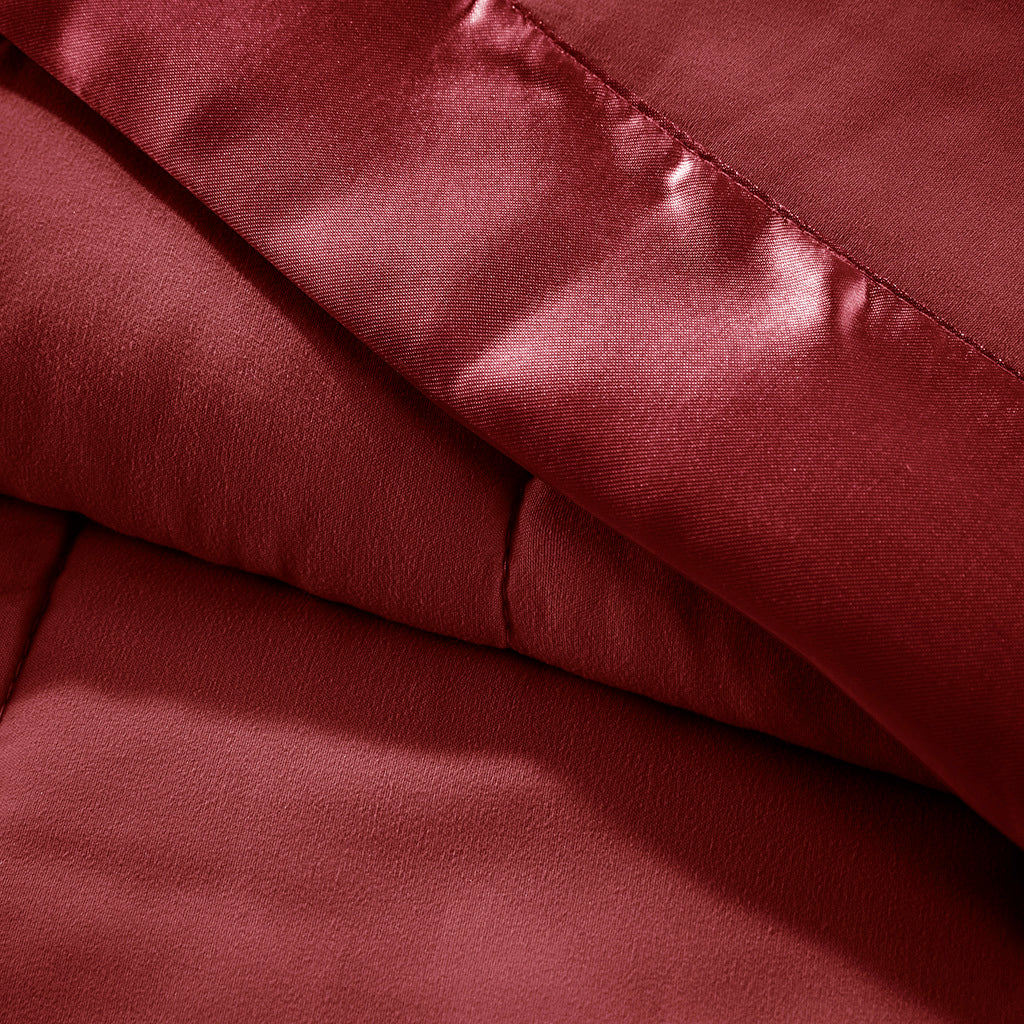 Close-up of Down Alternative Blanket Burgundy Twin - Budget Comfort showing soft texture and satin trim for a luxurious feel.